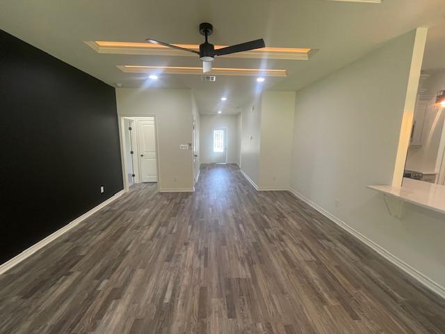 2303 White Wing Dr, Navasota, TX 77868 - empty room with a ceiling fan, wood finished floors, and baseboards