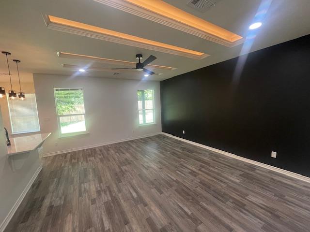 2303 White Wing Dr, Navasota, TX 77868 - spare room featuring dark wood finished floors, baseboards, a ceiling fan, a chandelier, and crown molding