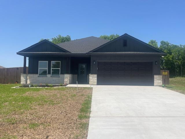 2303 White Wing Dr, Navasota, TX 77868 - single story home featuring a garage and concrete driveway