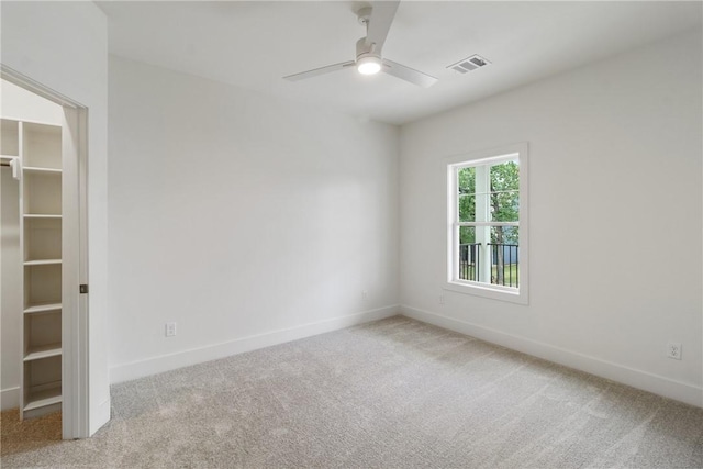 unfurnished room featuring carpet flooring, ceiling fan, and baseboards