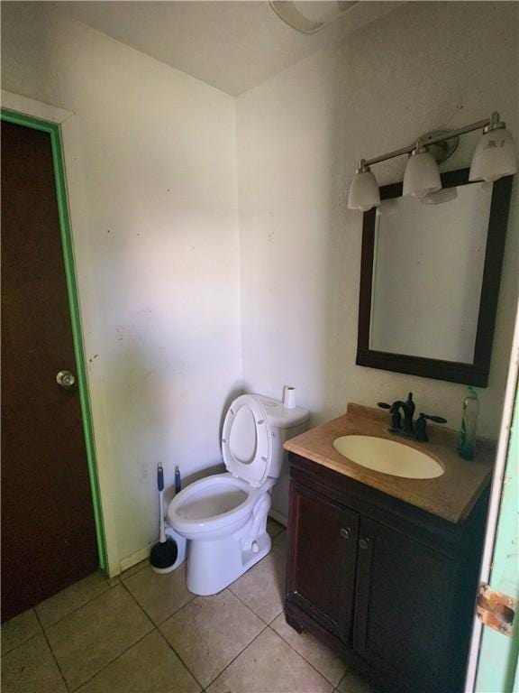 bathroom with vanity, tile patterned floors, and toilet