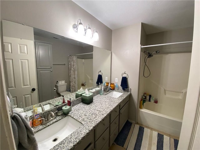 full bathroom with shower / tub combo with curtain, vanity, and toilet