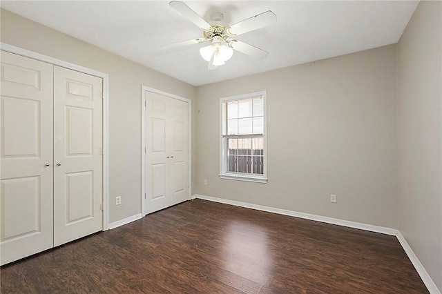 unfurnished bedroom featuring dark hardwood / wood-style floors and ceiling fan