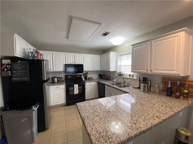 kitchen with kitchen peninsula, sink, white cabinetry, and black appliances