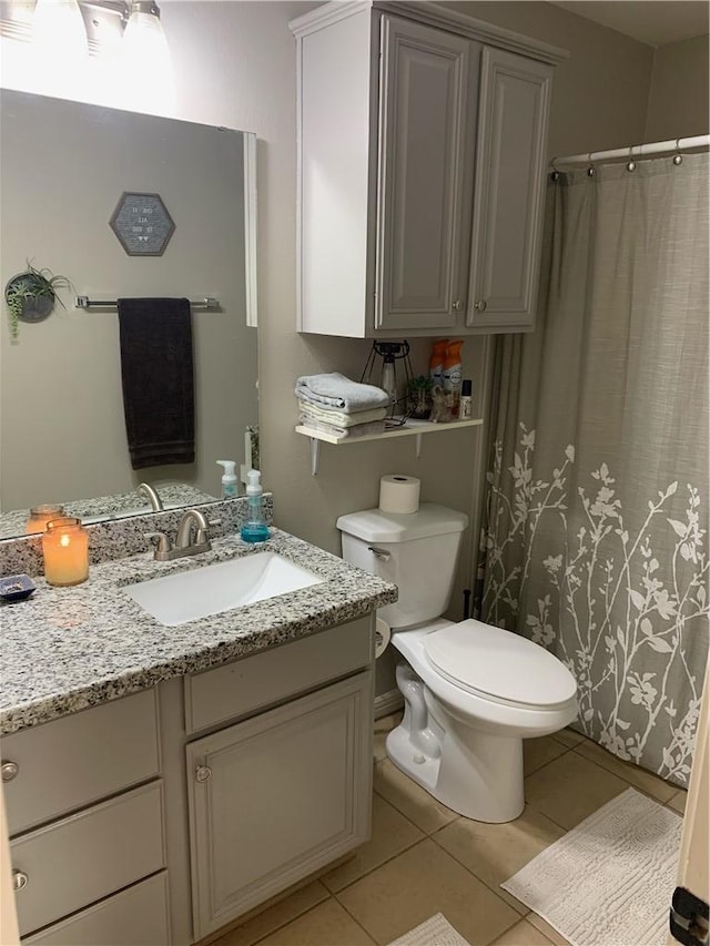 bathroom with tile patterned floors, vanity, and toilet