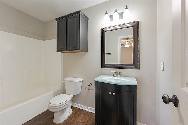 full bathroom featuring vanity, ceiling fan, toilet, wood-type flooring, and tub / shower combination