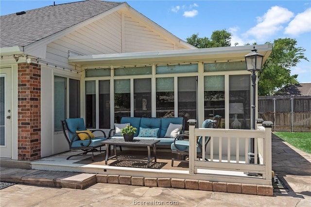 view of patio / terrace featuring outdoor lounge area and a sunroom