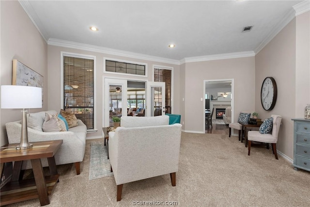 carpeted living room featuring ornamental molding