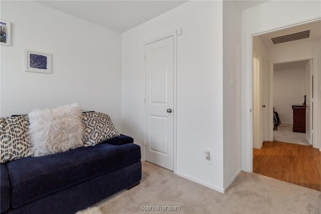 sitting room with light colored carpet