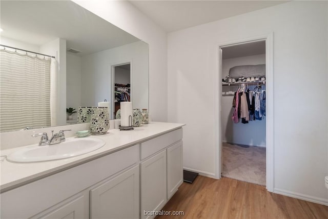 bathroom with vanity and hardwood / wood-style flooring