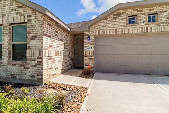 doorway to property with a garage