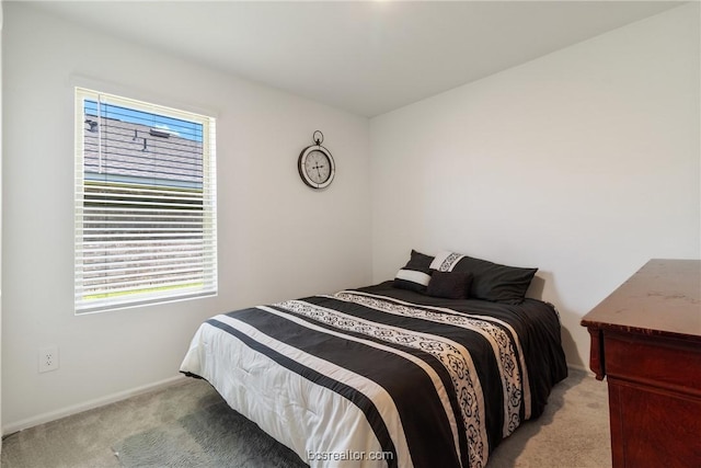 bedroom with multiple windows and light carpet