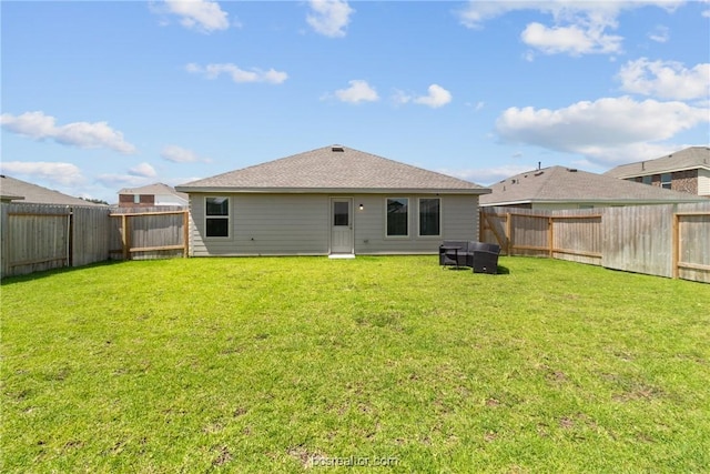 back of house featuring a lawn