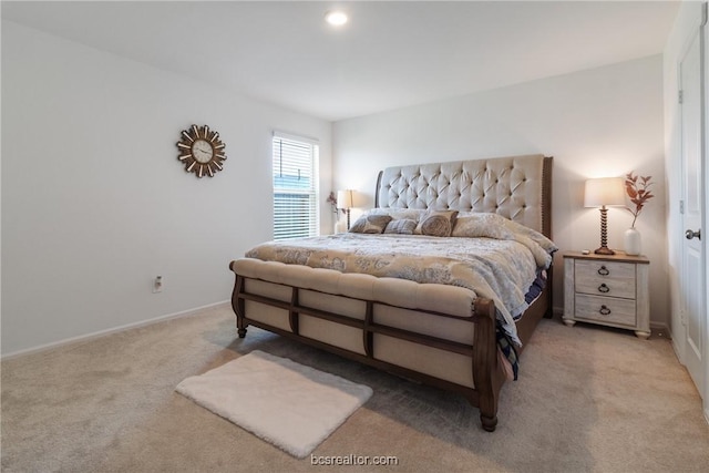 bedroom featuring light carpet