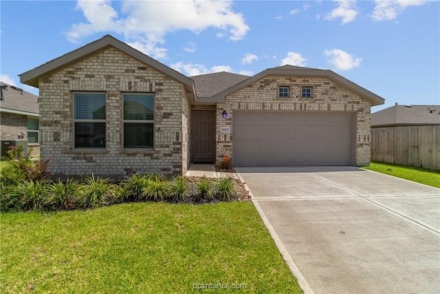 view of front of home with a garage and a front lawn