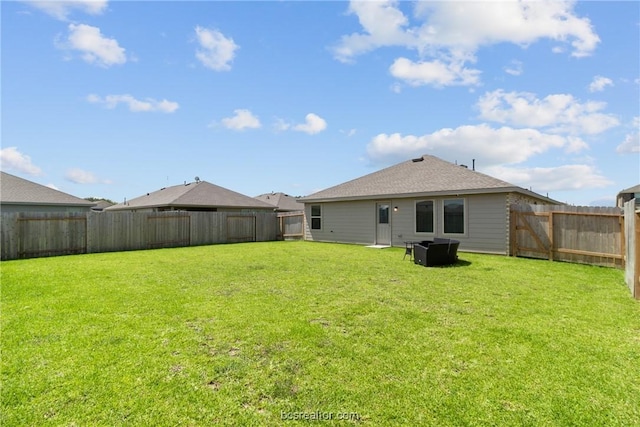 rear view of house with a yard