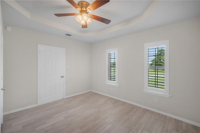 3500 Fazzino Ln, Bryan, TX 77807 - empty room with a raised ceiling, light wood-style flooring, and baseboards
