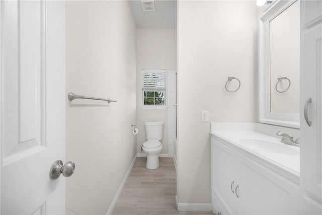 3500 Fazzino Ln, Bryan, TX 77807 - bathroom with vanity, wood finished floors, toilet, and baseboards
