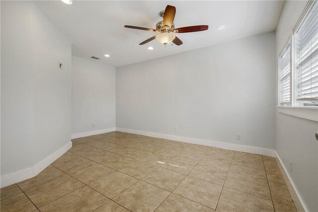 spare room featuring light tile patterned floors, visible vents, recessed lighting, and baseboards