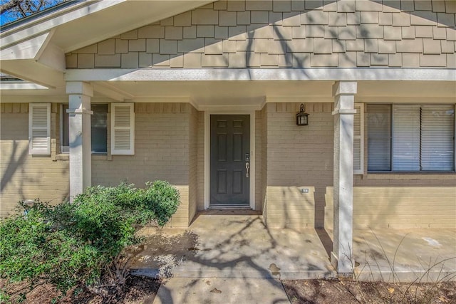 property entrance featuring brick siding