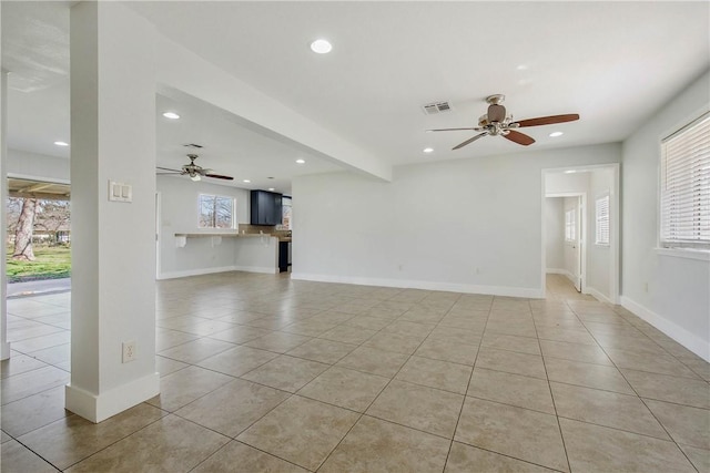 unfurnished living room with light tile patterned floors, visible vents, baseboards, and recessed lighting