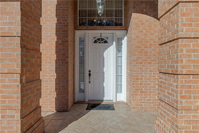 view of exterior entry with brick siding