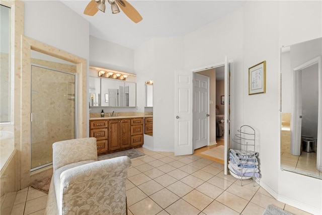 full bathroom with tile patterned floors, a shower stall, baseboards, ceiling fan, and vanity