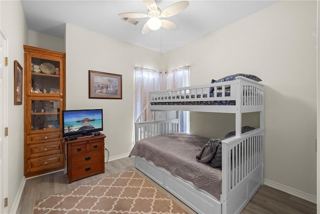 bedroom with visible vents, ceiling fan, baseboards, and wood finished floors