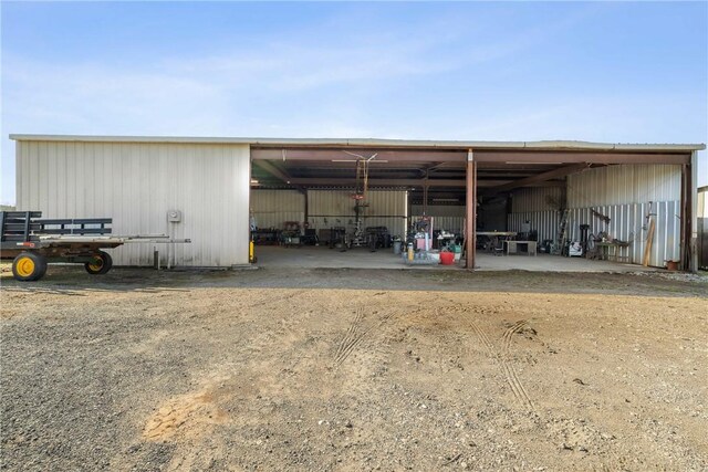 view of pole building featuring a carport and driveway