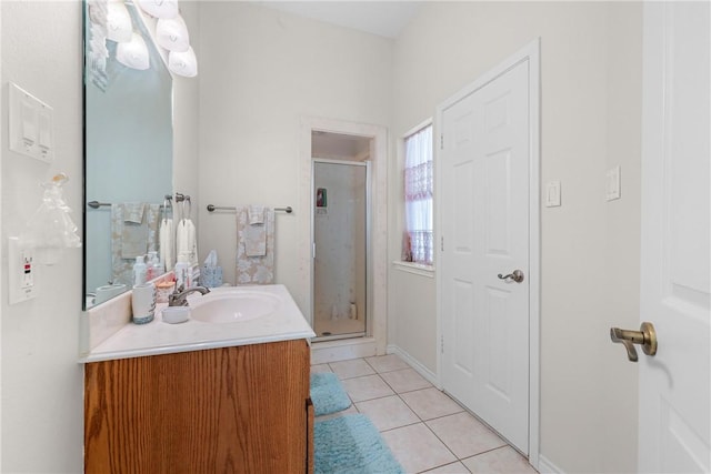 bathroom with a stall shower, vanity, and tile patterned flooring