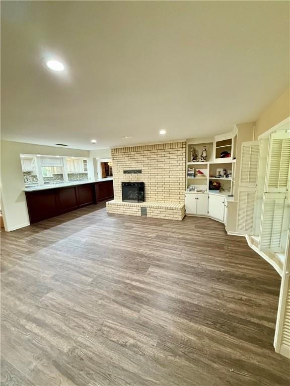 67 Fairway Dr, Hilltop Lakes, TX 77871 - unfurnished living room with a fireplace, wood finished floors, recessed lighting, and baseboards