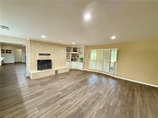 67 Fairway Dr, Hilltop Lakes, TX 77871 - unfurnished living room with dark wood-style floors, baseboards, and recessed lighting