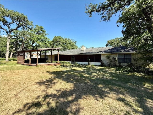 67 Fairway Dr, Hilltop Lakes, TX 77871 - rear view of property with a lawn, brick siding, and a chimney