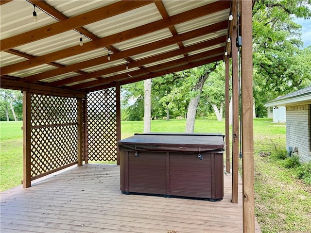 67 Fairway Dr, Hilltop Lakes, TX 77871 - wooden deck with a hot tub and a lawn