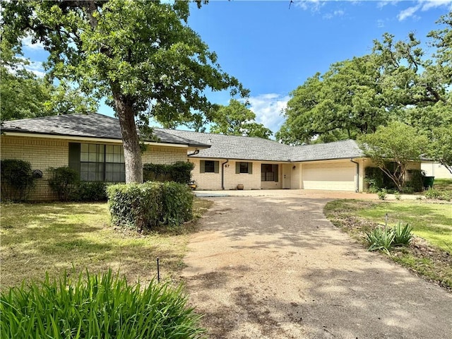 67 Fairway Dr, Hilltop Lakes, TX 77871 - single story home featuring asphalt driveway, brick siding, an attached garage, and a front lawn