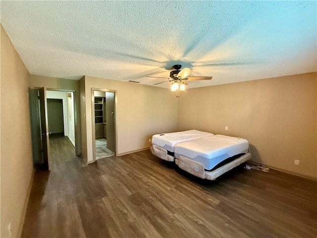 67 Fairway Dr, Hilltop Lakes, TX 77871 - bedroom featuring wood finished floors, a textured ceiling, ceiling fan, and baseboards