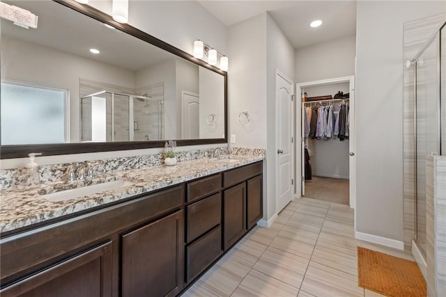 6317 Daytona Dr, College Station, TX 77845 - full bathroom with a shower stall, double vanity, a walk in closet, and a sink