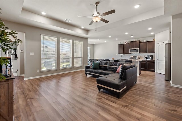 6317 Daytona Dr, College Station, TX 77845 - living area with a ceiling fan, a raised ceiling, wood finished floors, visible vents, and recessed lighting