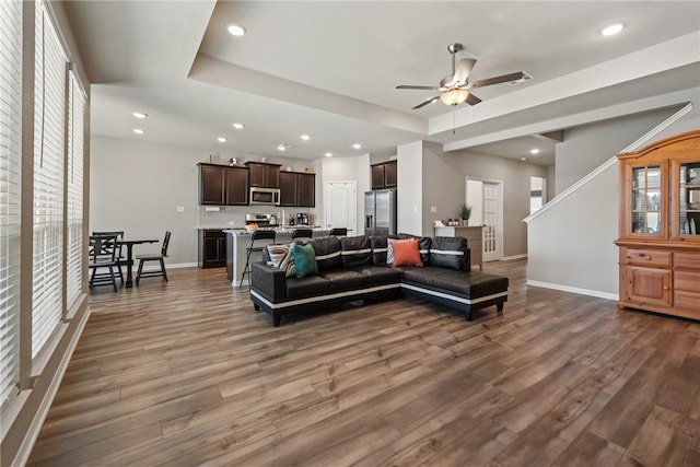 6317 Daytona Dr, College Station, TX 77845 - living room with a tray ceiling, recessed lighting, baseboards, a ceiling fan, and wood finished floors