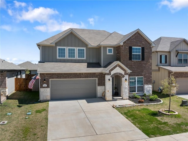 6317 Daytona Dr, College Station, TX 77845 - view of front of house featuring fence, an attached garage, stone siding, board and batten siding, and driveway