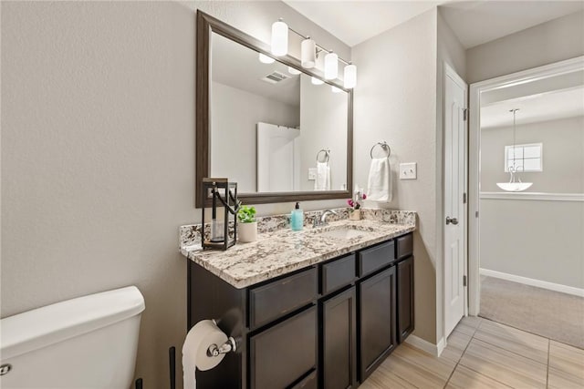 6317 Daytona Dr, College Station, TX 77845 - bathroom featuring baseboards, visible vents, toilet, and vanity
