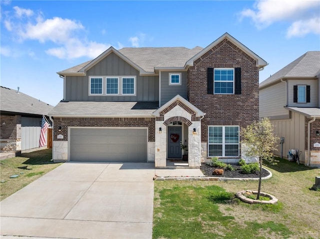 6317 Daytona Dr, College Station, TX 77845 - view of front of home with driveway, a front yard, an attached garage, brick siding, and board and batten siding