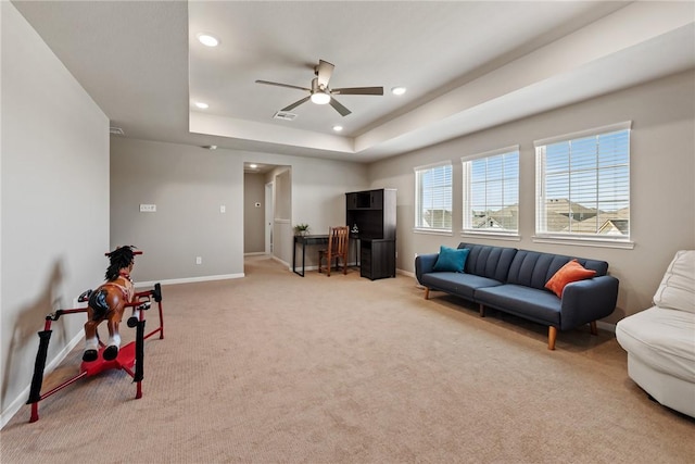 6317 Daytona Dr, College Station, TX 77845 - living area featuring a tray ceiling, light colored carpet, recessed lighting, baseboards, and ceiling fan