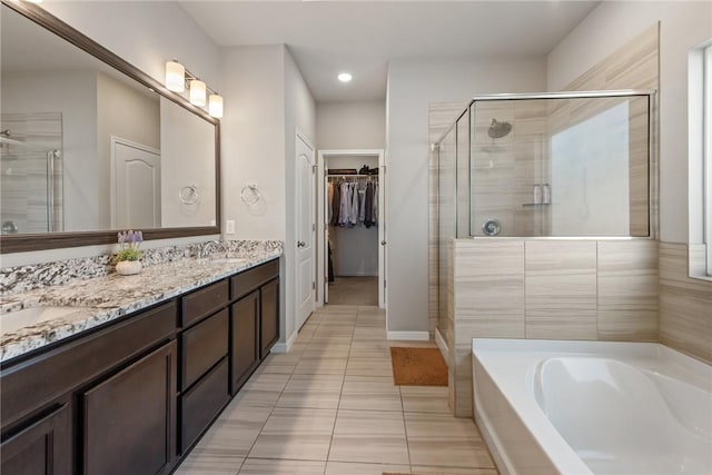6317 Daytona Dr, College Station, TX 77845 - full bathroom with a bath, double vanity, a stall shower, and a spacious closet