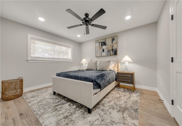 bedroom with ceiling fan and light wood-type flooring