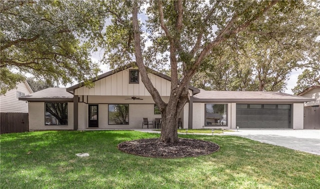 view of front of home with ceiling fan, a front lawn, and a garage