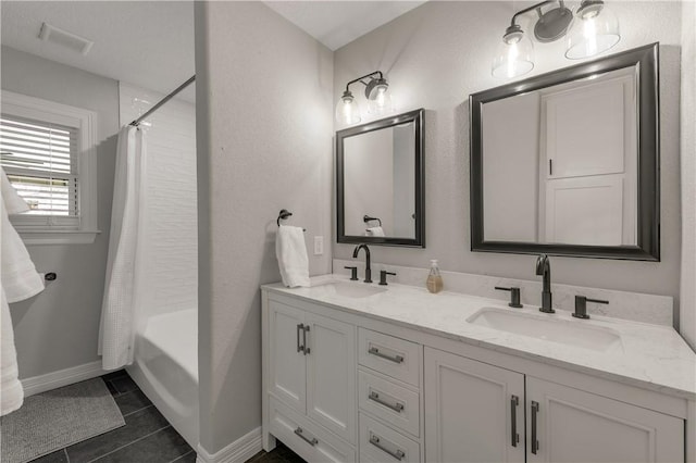 bathroom featuring vanity, tile patterned floors, and shower / bath combo with shower curtain