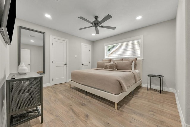 bedroom with ceiling fan and light hardwood / wood-style floors