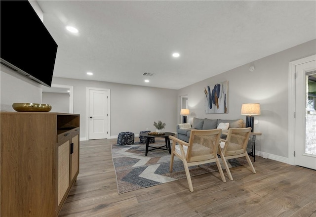 living room with light hardwood / wood-style flooring