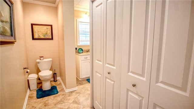 bathroom featuring crown molding and toilet